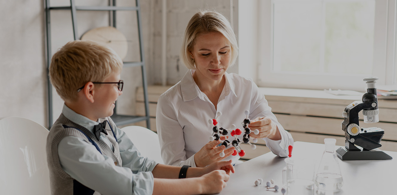 Female science tutor in Berekley studying chemistry with student